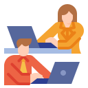 Two professionals focused on their laptops in a modern office setting.