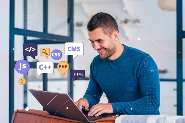 A man on a couch using a laptop with icons on the screen.
